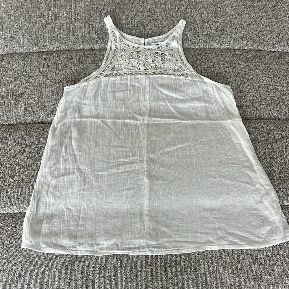White elegant tank top, with partially open design on top front